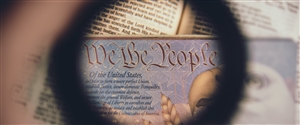 A black circle around the words We the People and a Bald Eagle from an official document